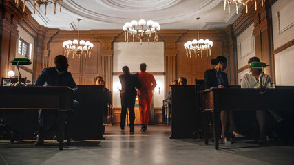 Cinematic Court of Law and Justice Trial Proceedings: Portrait of Accused Male Criminal in Orange Jumpsuit Led Away by Security Guard in Front of Jury. Convict Sentenced to Serve Jail Time.