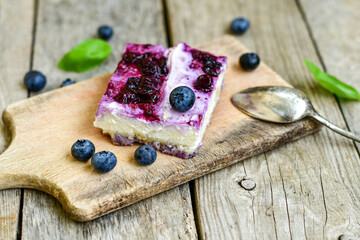 Homemade ketogenic  cheesecake with Blueberry   sauce .Healthy organic summer dessert  on wooden background