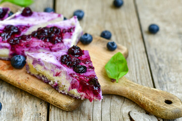 Homemade ketogenic  cheesecake with Blueberry   sauce .Healthy organic summer dessert  on wooden...