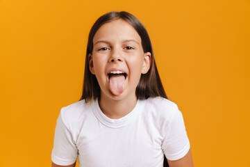 White brunette girl wearing t-shirt showing her tongue at camera © Drobot Dean