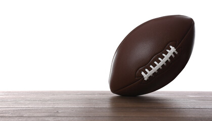 American football ball on wooden table against white background. Space for text
