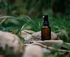 Cosmetic spray with a pipette on a natural background