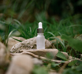 White сosmetic bottle with pipette on natural background