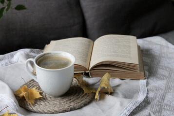 a cup of black coffee and a book