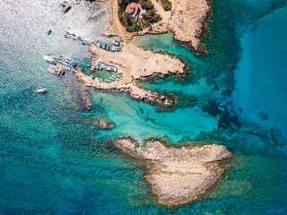 Aerial view on clear blue water of bay with boats. Cyprus