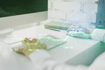 Multi exposure of stats data illustration with hands typing on computer keyboard on background, computing and analytics concept