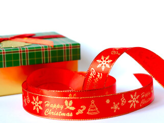 New Year's red ribbon with the inscription Merry Christmas on the background of a gift box