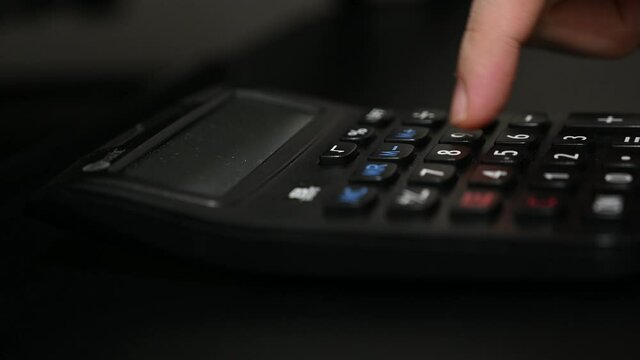 A student is doing mathematics by using electronic calculator.  