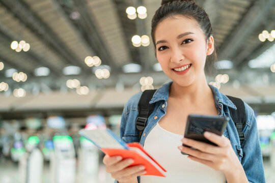happiness smiling asian adult female wear casual cloth hand gesture showing passport and blank screen smartphone at aitport terminal,asian female ready to travel after lockdown is over at airport