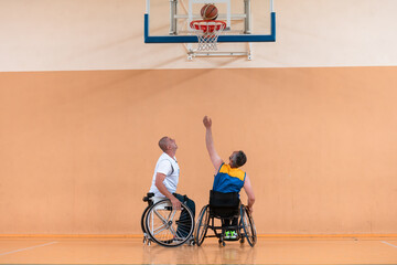 Disabled War veterans mixed race and age basketball teams in wheelchairs playing a training match...