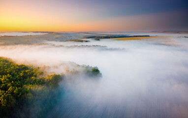 Awesome misty view of the countryside with the rays of morning light.
