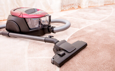 Vacuum cleaner in the room on the carpet, cleanliness in the house, cleaning