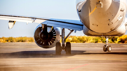 The plane is preparing to fly at the airport. Airplane on the runway at the airport. The turbine of...