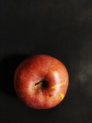 red apple on black background
