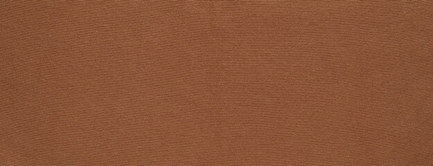Banner with texture of smooth knitted red brown sweater with pattern. Top view, close-up. Handmade knitting wool or cotton fabric texture. Background of knitting patterns.