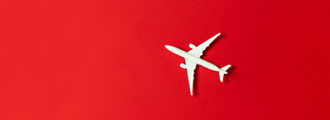 Creative composition with passenger plane on red background. Summer travel or vacation