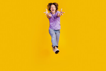 Fototapeta na wymiar Photo of crazy excited carefree funny man jump open mouth wear casual jeans clothes on yellow background