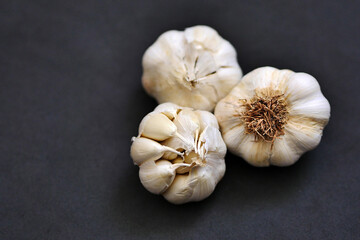 whole heads of garlic on a black background, close-up garlic,garlic for the winter,
