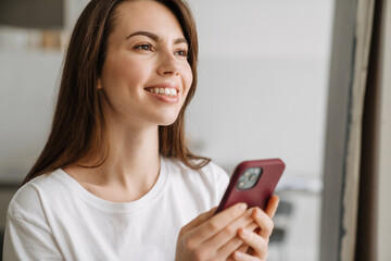 Smiling young woman in lounge wear standing