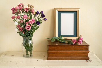 Memorial still life with frame and flowers.