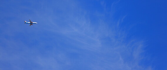 A passenger aircraft flying past from the left