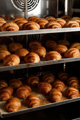 close up view of croissants on pan in stove