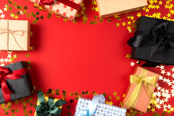 Many beautiful gifts with bows for important events on a red starry background with place for text.