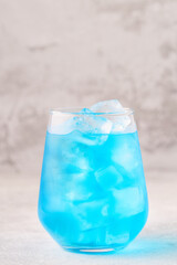Refreshing blue drink or cocktail with ice
