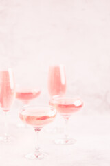 Champagne or wine in glasses on light background.