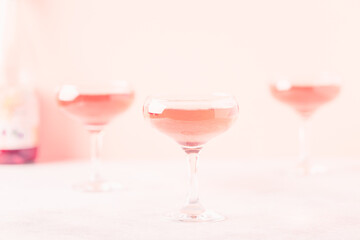 Champagne or wine in glasses on light background.