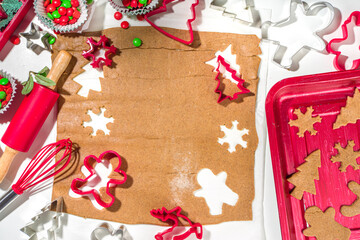 Christmas, New Year cooking background. Baking ingredients and utensils - gingerbread dough, cookie cutters, rolling pin. Making festive Christmas sweet cookies bright festive red white concept