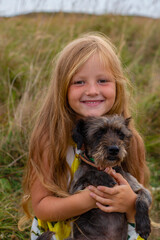 blonde girl with the dog in a meadow