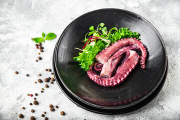 octopus food in a plate seafood second course fresh ready to eat meal snack on the table copy space food background rustic. top view keto or paleo vegetarian food no meat pescetarian diet