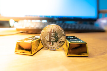 Bitcoin laying on stacked gold bars (gold ingots) rendered with shallow depth of field. Bitcoin as...