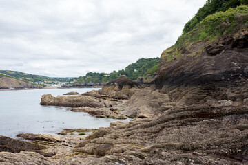 Fototapeta na wymiar Rocky beach in England, ocean and cliffs