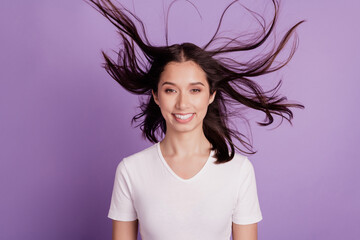 Portrait of cheerful positive carefree lady nice face toothy white smile wind blow hairdo on purple...