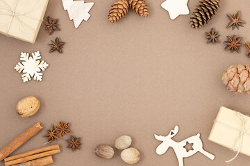 Fototapeta na wymiar Christmas background with gift boxes, cones, wooden toys and spices 