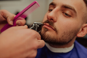 Young Man in Barbershop Hair Care Service Concept. Selective focus