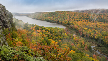 Fototapeta premium Misty, moody morning at Lake of the Clouds, in the Porcupine Mountain Wilderness State Park, near Ontonogon, Michigan.