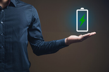 a man holding a battery icon in his hand