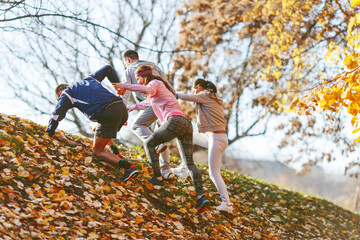 Group of friends in sportswear jogging at the park on beautiful day.Autumn concept.	
