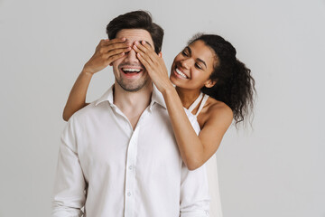 Black woman covering her boyfriend's eyes and laughing