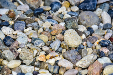 Rocks sea beach or stones background, Many small stones in assorted colors, Abstract rough wallpaper nature concept