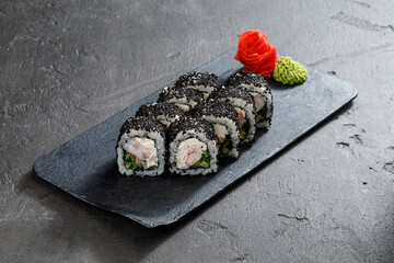 sushi on a plate on grey stone table