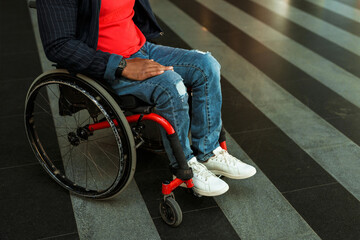 Obraz premium Man wearing jeans sitting in wheelchair at station
