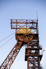 The elevator of the hoist shaft in the black coal mine. Coal mine hoist against the sky. Photo taken under natural lighting conditions