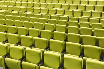 rows of green seats in theatre