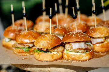 Close up of mini hamburgers at catering event - obrazy, fototapety, plakaty