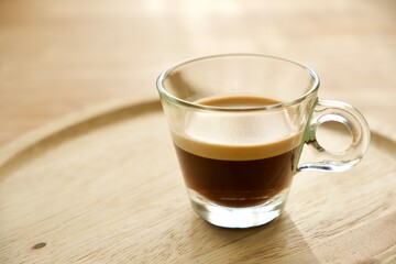 Cup of coffee on a wooden plate