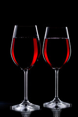 Glasses of wine on a black background.